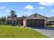 Charming single-story home with a well-maintained lawn, a two-car garage, and beautiful landscaping at 925 S Dean Cir, Deltona, FL 32738