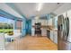 The eat-in kitchen has stainless steel appliances, a window overlooking the front yard, and white cabinets at 925 S Dean Cir, Deltona, FL 32738