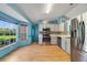 Bright kitchen featuring new appliances, hardwood floors, and ample sunlight at 925 S Dean Cir, Deltona, FL 32738