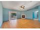 Spacious living room featuring hardwood floors, fireplace, and sliding door access to patio at 925 S Dean Cir, Deltona, FL 32738