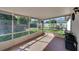 Enclosed patio with open view to a well maintained backyard with mature landscaping at 925 S Dean Cir, Deltona, FL 32738