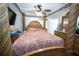 Ornate bedroom with a four-poster bed, ceiling fan and wood trim at 5723 Harcourt Ave, Orlando, FL 32810