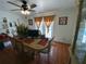 Bright dining room with tile flooring, a window and a table set for six, perfect for Gathering meals and pool view at 5723 Harcourt Ave, Orlando, FL 32810