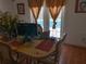 Bright dining room with tile flooring, a window and a table set for six, perfect for Gathering meals and pool view at 5723 Harcourt Ave, Orlando, FL 32810