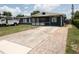 Charming single-story home with a well-maintained lawn and a long driveway at 5723 Harcourt Ave, Orlando, FL 32810