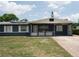 Charming single-story home featuring a blue exterior, brick accents, and a well-maintained lawn and driveway at 5723 Harcourt Ave, Orlando, FL 32810