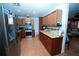 A well-equipped kitchen with stainless steel appliances and warm wood cabinetry at 5723 Harcourt Ave, Orlando, FL 32810