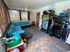 Enclosed patio with tile, lounge seating, ceiling fan, and an extra refrigerator, offering a versatile relaxation space at 5723 Harcourt Ave, Orlando, FL 32810