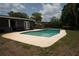 Backyard with a private swimming pool, patio and surrounding greenery at 5723 Harcourt Ave, Orlando, FL 32810