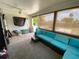 The sunroom features a comfortable seating area, ceiling fan, and views of the pool at 5723 Harcourt Ave, Orlando, FL 32810
