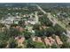 An aerial view showcases the community with mature trees, a pool, and convenient access to major roads at 104 Oaks Ct, Sanford, FL 32771
