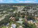 An aerial view of community shows mature trees, a pool, a tennis court, and convenient road access at 104 Oaks Ct, Sanford, FL 32771