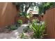 Landscaped backyard featuring a brick walkway, mature trees, and privacy fence at 104 Oaks Ct, Sanford, FL 32771