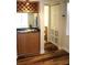 Home bar area featuring wood cabinets, a sink and storage for wine glasses at 104 Oaks Ct, Sanford, FL 32771