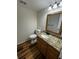 Modern bathroom with granite countertops, wood laminate flooring at 104 Oaks Ct, Sanford, FL 32771
