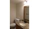 Half bathroom with granite vanity top, dark faucet and ornate framed mirror at 104 Oaks Ct, Sanford, FL 32771