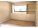 This bedroom features built-in shelving and cabinets and a window letting in lots of light at 104 Oaks Ct, Sanford, FL 32771