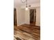 Inviting dining room features modern lighting fixture and beautiful flooring, adjacent to staircase and stainless steel refrigerator at 104 Oaks Ct, Sanford, FL 32771