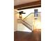 Open entryway with staircase, black iron railings, wooden beams, and hardwood floors at 104 Oaks Ct, Sanford, FL 32771