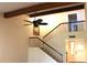 Entryway with staircase, iron railings, wooden beams, neutral paint, and hardwood floors at 104 Oaks Ct, Sanford, FL 32771