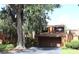 Exterior view of home with a mature tree and well-maintained landscaping, and attached garage at 104 Oaks Ct, Sanford, FL 32771