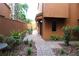 Charming brown exterior showcasing a landscaped walkway and inviting facade at 104 Oaks Ct, Sanford, FL 32771