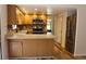 Modern kitchen with stainless steel appliances, breakfast bar, and hardwood floors at 104 Oaks Ct, Sanford, FL 32771