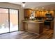 Modern kitchen with oak cabinets, stainless steel appliances, modern countertops and hardwood floors at 104 Oaks Ct, Sanford, FL 32771