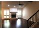 Open living room with fireplace, fan, hardwood floors, neutral paint, and windows with shutters at 104 Oaks Ct, Sanford, FL 32771