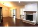 Large living room features a fireplace, hardwood floors, plantation shutters, and glass doors to patio at 104 Oaks Ct, Sanford, FL 32771