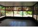 Enclosed patio features tiled floors with serene views of the landscaped garden at 104 Oaks Ct, Sanford, FL 32771