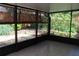 Enclosed porch features tiled floor, natural bamboo shades, and view of backyard at 104 Oaks Ct, Sanford, FL 32771