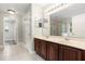 Bathroom features a double sink vanity, shower, and neutral tile flooring at 1203 Stone Harbour Rd, Winter Springs, FL 32708