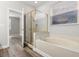 Bright bathroom featuring a bathtub, a glass-enclosed shower, and a window at 1203 Stone Harbour Rd, Winter Springs, FL 32708