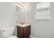 Cozy bathroom with toilet, vanity with sink, and a window at 1203 Stone Harbour Rd, Winter Springs, FL 32708