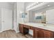 Well-lit bathroom featuring double sinks, wooden cabinets, and a large mirror at 1203 Stone Harbour Rd, Winter Springs, FL 32708