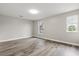 A bedroom with hardwood floors and two windows with outside views at 1203 Stone Harbour Rd, Winter Springs, FL 32708