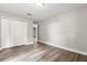 A bedroom featuring hardwood floors, neutral walls, closet, and an open door at 1203 Stone Harbour Rd, Winter Springs, FL 32708