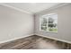 Neutral bedroom with vinyl wood floors and large bright window at 1203 Stone Harbour Rd, Winter Springs, FL 32708