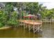 View of a wooden dock with a small shelter on the water at 1203 Stone Harbour Rd, Winter Springs, FL 32708