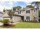 Charming two-story home with landscaped front yard and attached two-car garage at 1203 Stone Harbour Rd, Winter Springs, FL 32708