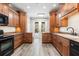 Well-equipped kitchen featuring wood cabinetry, granite countertops, and stainless steel appliances at 1203 Stone Harbour Rd, Winter Springs, FL 32708