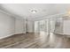 Bright living room with hardwood flooring, neutral paint, white trim, and staircase at 1203 Stone Harbour Rd, Winter Springs, FL 32708