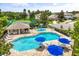 Community pool featuring a splashpad, lounge chairs, and tables with bright blue umbrellas at 1203 Stone Harbour Rd, Winter Springs, FL 32708