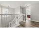 Bright staircase with wood floors and white railing leading to the second floor at 1203 Stone Harbour Rd, Winter Springs, FL 32708