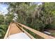 Wooden walkway with railing surrounded by greenery at 1203 Stone Harbour Rd, Winter Springs, FL 32708