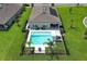 Aerial view of a home with a pool and solar panel in a manicured backyard, perfect for relaxing and entertaining at 1313 Middle Lake Dr, Ormond Beach, FL 32174