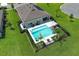 Aerial view of backyard featuring a private pool, patio furniture, and manicured lawn at 1313 Middle Lake Dr, Ormond Beach, FL 32174
