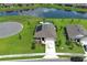 Beautiful aerial view of house with private pool, well-manicured lawn, and scenic lake, creating a serene living environment at 1313 Middle Lake Dr, Ormond Beach, FL 32174