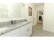 Bright bathroom with double sinks, granite counters, and gray tile floors at 1313 Middle Lake Dr, Ormond Beach, FL 32174